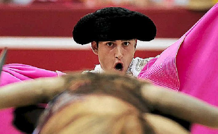 HORNS OF A DILEMMA: Bull fighter Alberto Aguilar eyes off a bull during a bullfight in Pamplona. HORNS OF A DILEMMA: Bull fighter Alberto Aguilar eyes off a bull during a bullfight in Pamplona.
